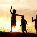 Kids playing on sunset